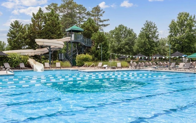 view of swimming pool featuring a water slide