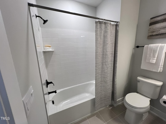 bathroom with tile patterned floors, toilet, and shower / bath combo with shower curtain