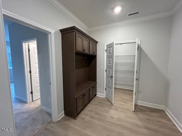 mudroom with crown molding and light hardwood / wood-style flooring