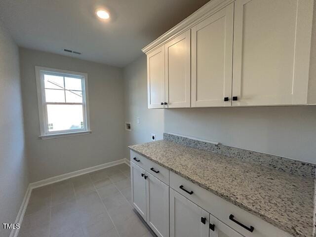 laundry room with cabinets, washer hookup, light tile patterned floors, and hookup for an electric dryer