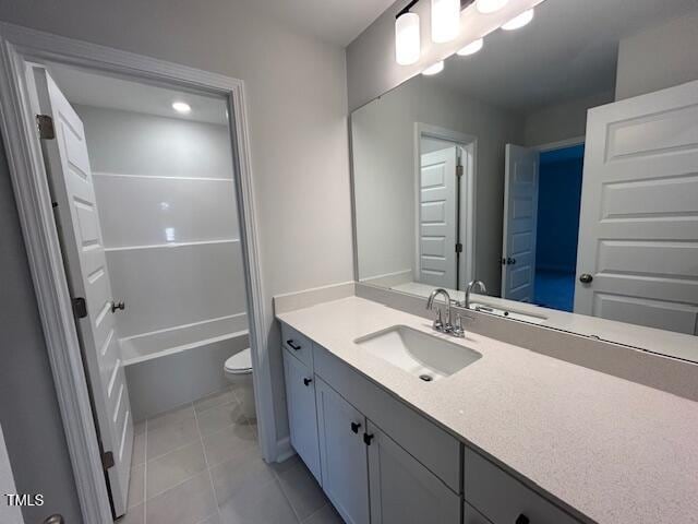 bathroom with tile patterned floors, vanity, and toilet