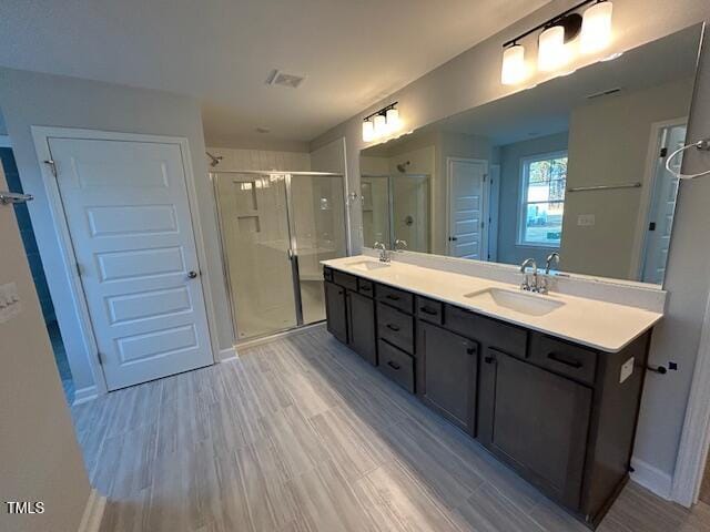 bathroom featuring vanity, an enclosed shower, and hardwood / wood-style flooring