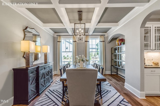 dining space with coffered ceiling, crown molding, beam ceiling, an inviting chandelier, and light hardwood / wood-style floors