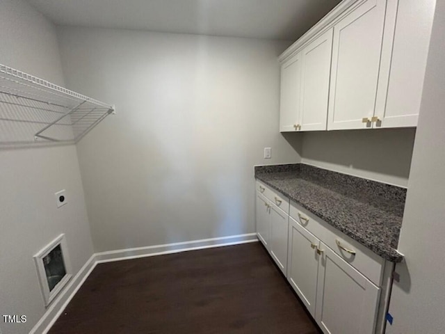 washroom featuring cabinets, electric dryer hookup, dark hardwood / wood-style flooring, and heating unit