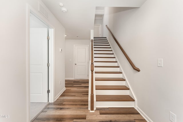 staircase featuring wood-type flooring