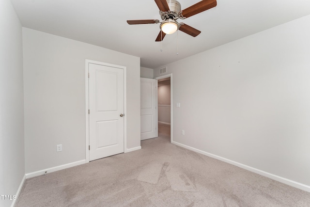 unfurnished bedroom with ceiling fan and light carpet