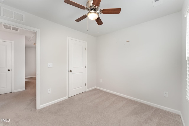 unfurnished bedroom with ceiling fan and carpet floors