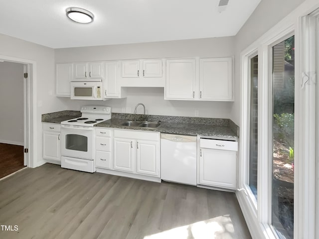 kitchen featuring sink, white cabinetry, hardwood / wood-style floors, and white appliances