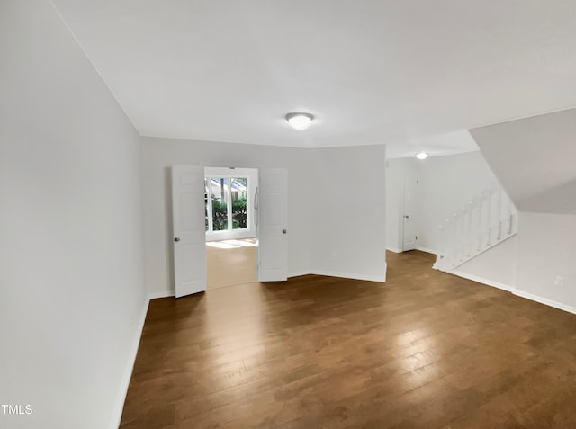 additional living space with dark wood-type flooring