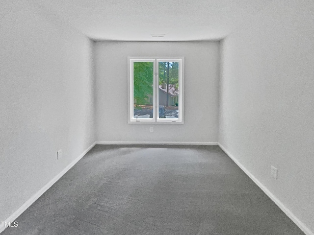 carpeted spare room with baseboards