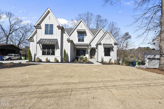 modern inspired farmhouse with a standing seam roof, metal roof, board and batten siding, and brick siding