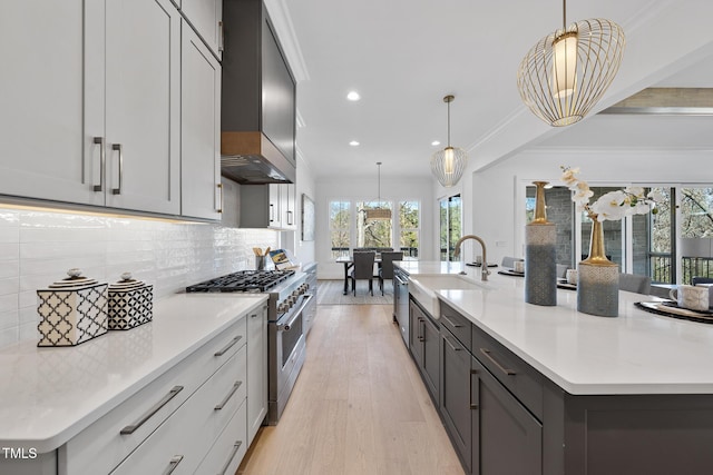 kitchen with stainless steel appliances, ornamental molding, backsplash, and a sink