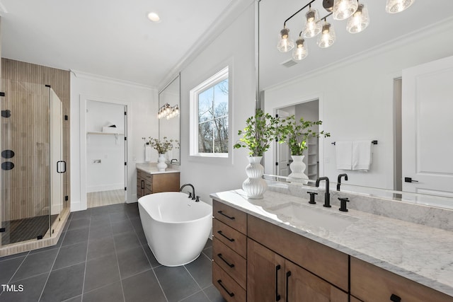 bathroom with tile patterned flooring, vanity, a soaking tub, a shower stall, and crown molding