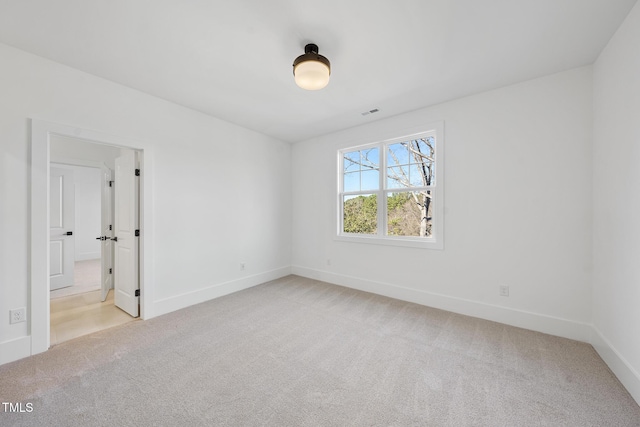 unfurnished bedroom with light colored carpet and baseboards