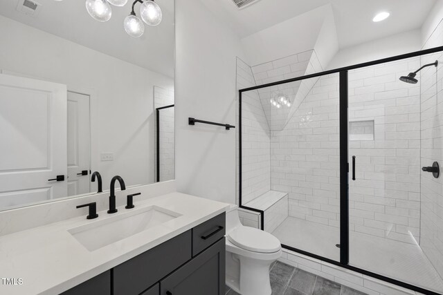 bathroom featuring toilet, a stall shower, vanity, and visible vents