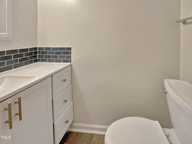 bathroom featuring hardwood / wood-style floors, vanity, and toilet