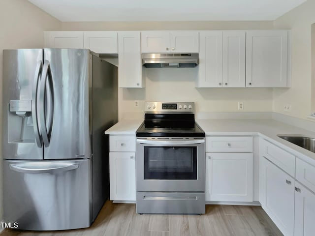 kitchen featuring light hardwood / wood-style flooring, white cabinetry, and appliances with stainless steel finishes