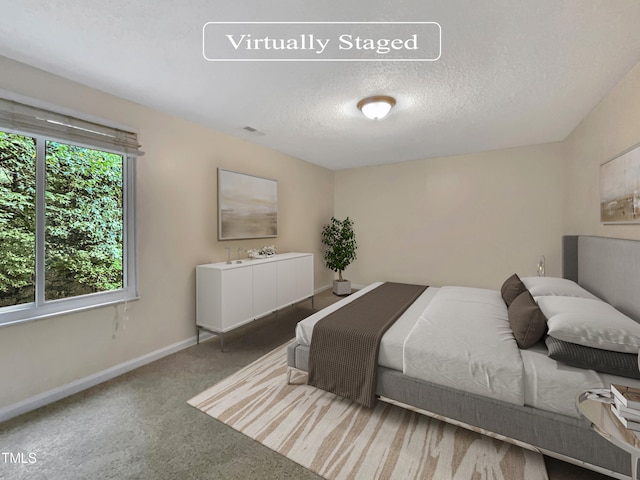 carpeted bedroom with a textured ceiling