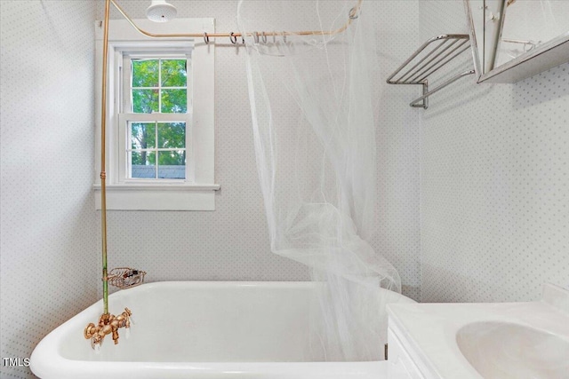 bathroom featuring vanity and independent shower and bath