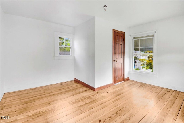 unfurnished room with light hardwood / wood-style floors