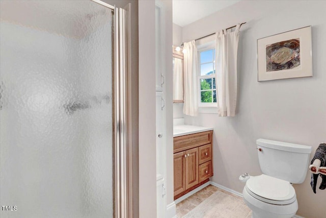 bathroom featuring vanity, toilet, and walk in shower