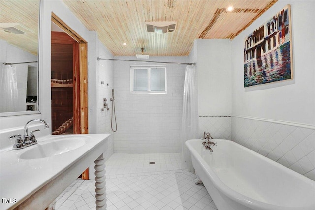 bathroom with tile patterned flooring, independent shower and bath, sink, wood ceiling, and tile walls