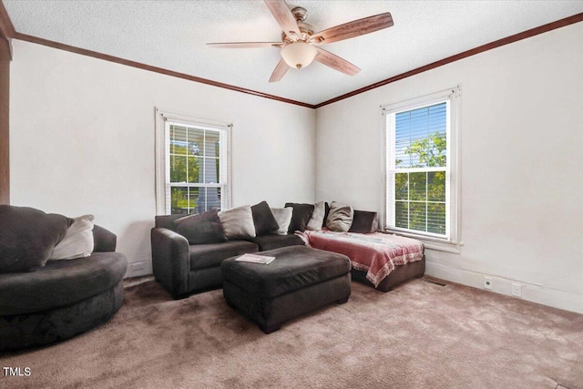 living room with a textured ceiling, carpet, ceiling fan, and crown molding