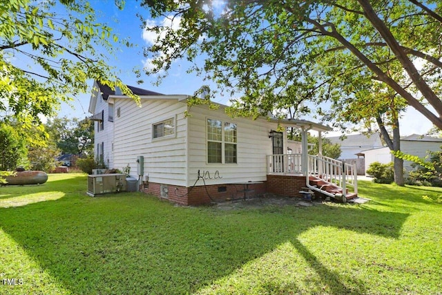 rear view of property with a yard