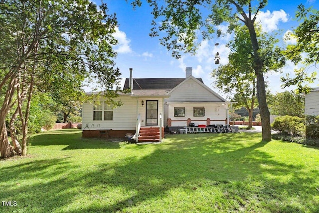 back of house featuring a yard