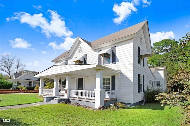 view of front of house with a porch and a front lawn