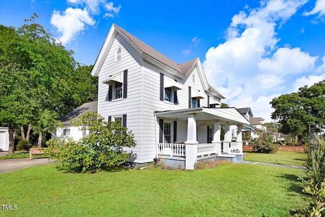 view of front facade with covered porch and a front yard