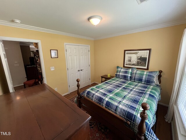 bedroom featuring hardwood / wood-style flooring, a closet, and crown molding