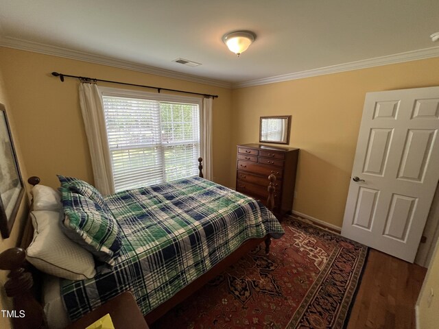 bedroom featuring hardwood / wood-style floors and ornamental molding