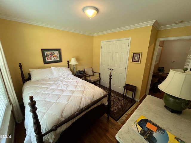 bedroom with a closet, crown molding, and dark hardwood / wood-style flooring