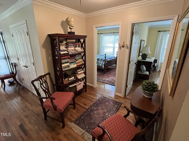 sitting room featuring crown molding and wood-type flooring