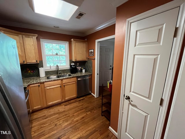 kitchen featuring backsplash, sink, appliances with stainless steel finishes, light hardwood / wood-style floors, and crown molding