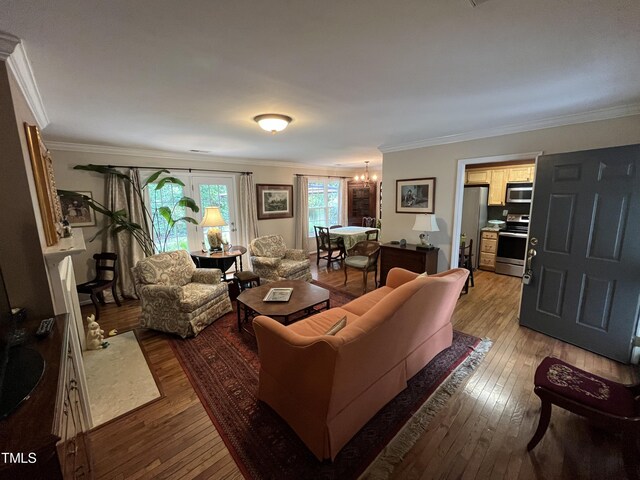 living room with hardwood / wood-style floors and crown molding