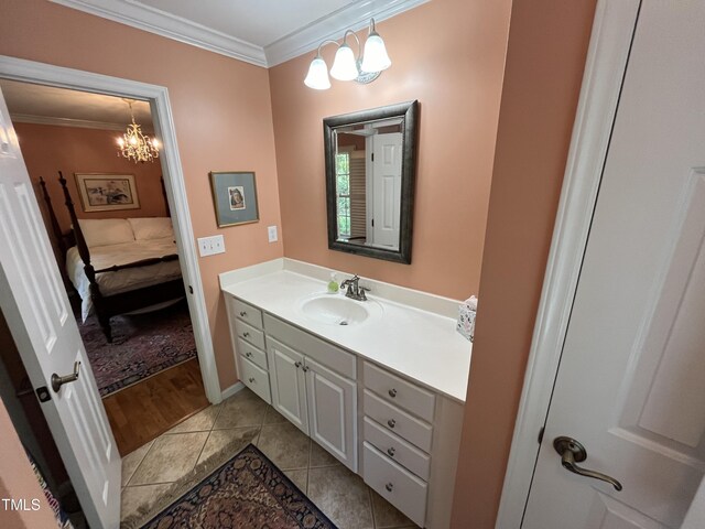 bathroom featuring ornamental molding, an inviting chandelier, vanity, and wood-type flooring