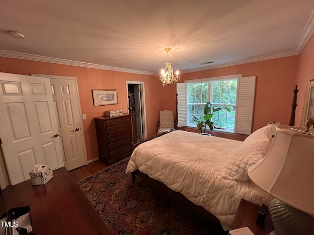 bedroom with dark hardwood / wood-style floors, an inviting chandelier, and ornamental molding