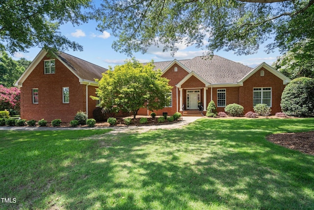 view of front of home with a front lawn and brick siding