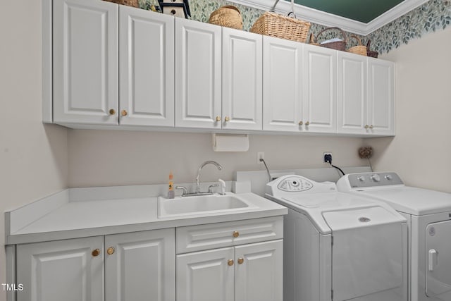 laundry room featuring cabinet space, a sink, and washing machine and clothes dryer