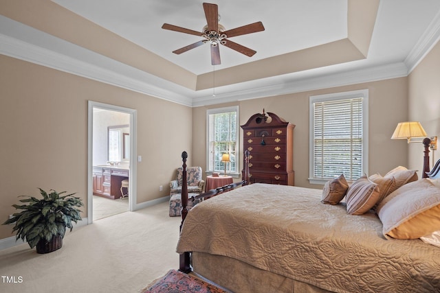 bedroom featuring a raised ceiling, light colored carpet, crown molding, and baseboards