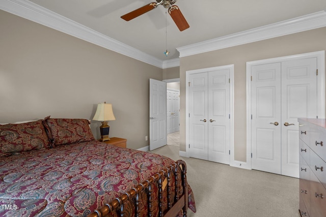 bedroom with ceiling fan, light carpet, multiple closets, baseboards, and crown molding