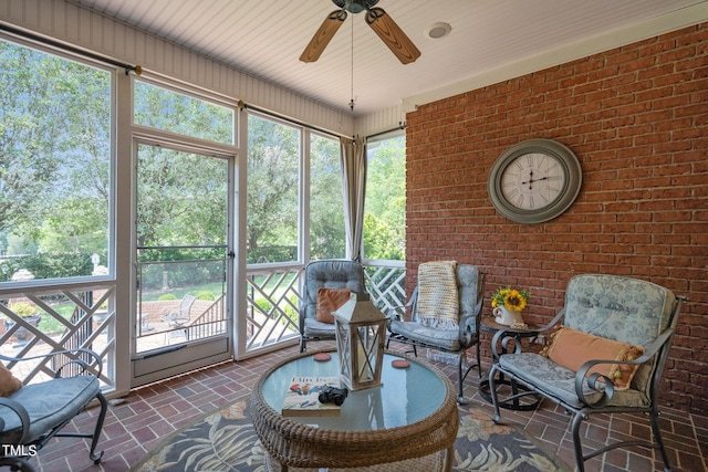 sunroom / solarium featuring ceiling fan