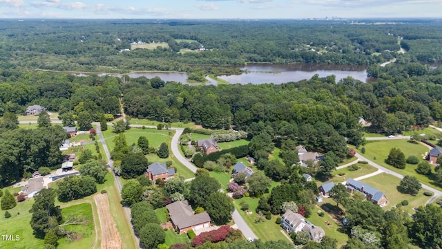 birds eye view of property with a water view, a residential view, and a view of trees