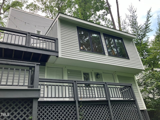 view of side of home featuring a balcony