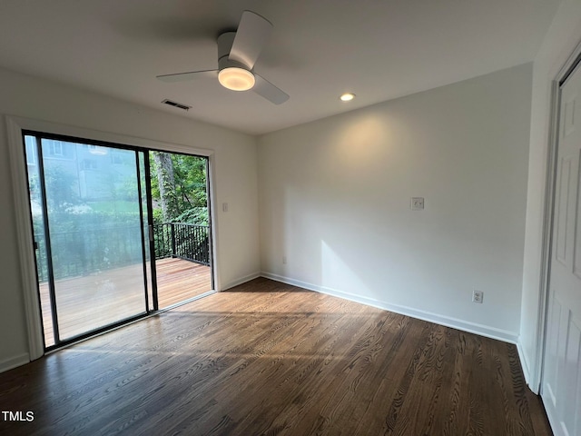 empty room featuring ceiling fan and dark hardwood / wood-style floors