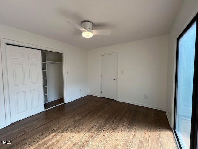 unfurnished bedroom with ceiling fan, a closet, and dark hardwood / wood-style flooring