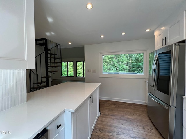 kitchen featuring stainless steel fridge, white cabinetry, and dark wood-type flooring