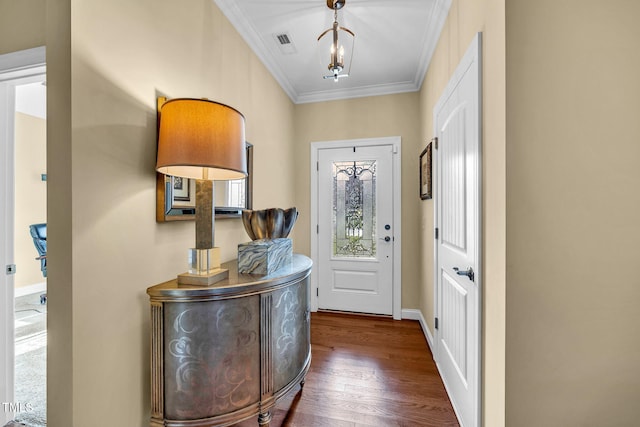 foyer with ornamental molding, dark wood-style flooring, visible vents, and baseboards